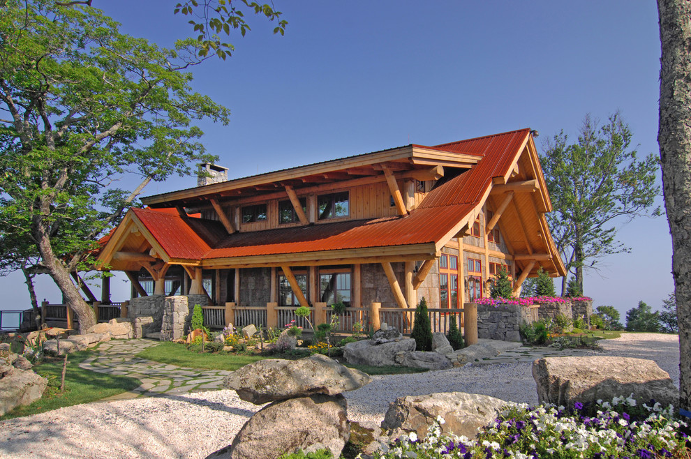 Mid-sized country two-storey brown exterior in Charlotte with wood siding.