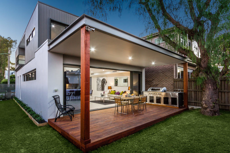 This is an example of a small contemporary backyard deck in Sydney with an outdoor kitchen and a pergola.