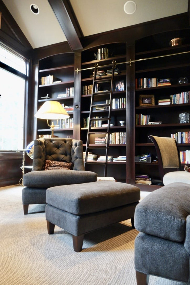 Photo of a contemporary enclosed living room in Cleveland with a library, carpet, beige floor, vaulted and wood walls.