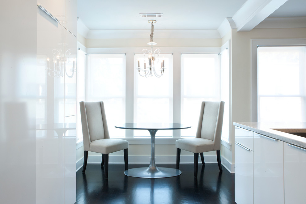 Example of a small transitional u-shaped dark wood floor and brown floor enclosed dining room design with a single-bowl sink, flat-panel cabinets, white cabinets, marble countertops, white backsplash, porcelain backsplash, stainless steel appliances and no island