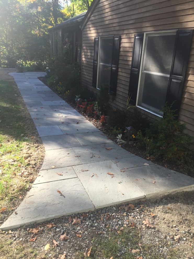 Design ideas for a large transitional partial sun backyard retaining wall landscape.