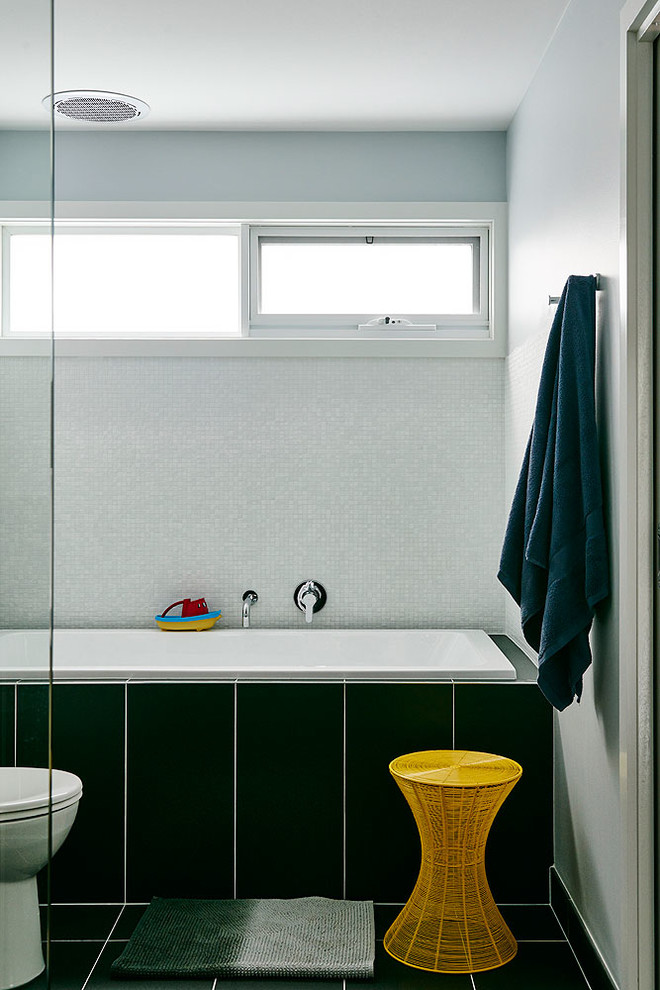 Large transitional 3/4 bathroom in Melbourne with furniture-like cabinets, white cabinets, an alcove tub, a corner shower, a two-piece toilet, gray tile, cement tile, grey walls, cement tiles, a drop-in sink, granite benchtops, blue floor and a hinged shower door.