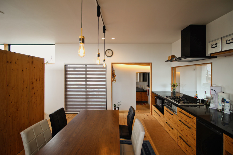 Contemporary kitchen/dining combo in Other with white walls, medium hardwood floors and brown floor.