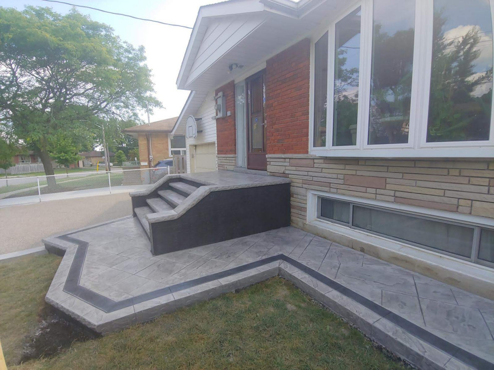 Mid-sized modern front yard verandah in Toronto with a container garden and stamped concrete.