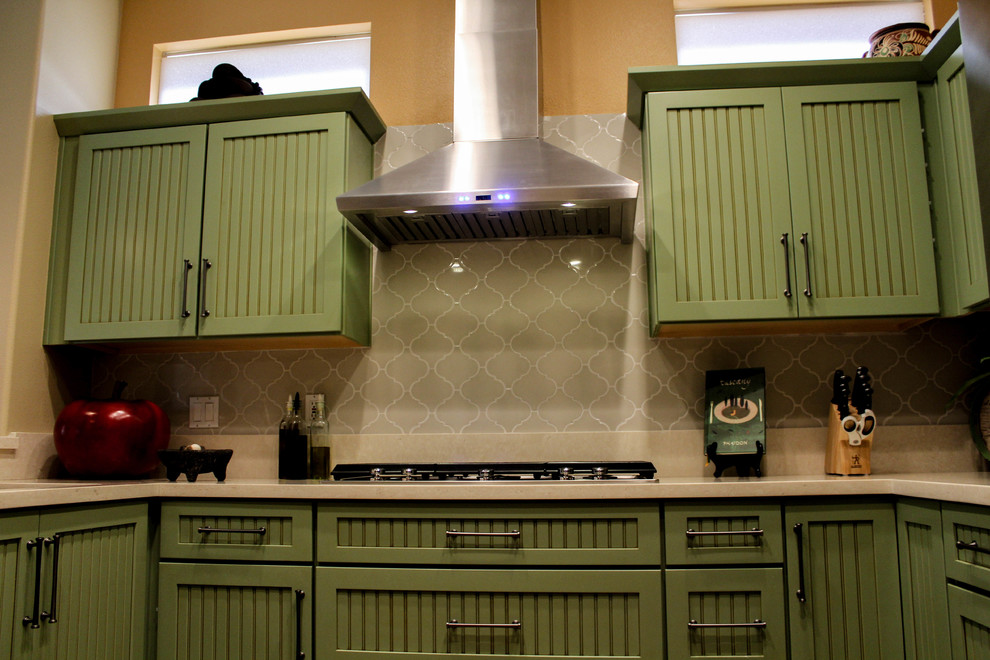 Example of a mid-sized classic u-shaped porcelain tile and beige floor eat-in kitchen design with an undermount sink, beaded inset cabinets, green cabinets, quartz countertops, beige backsplash, ceramic backsplash, stainless steel appliances, a peninsula and beige countertops
