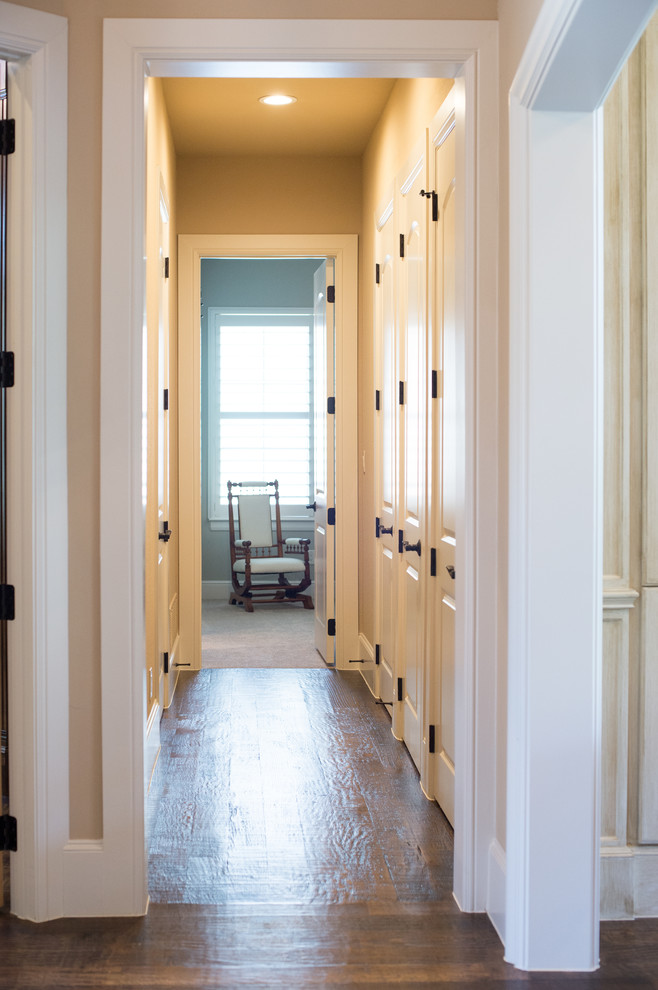 Design ideas for a mid-sized traditional hallway in Dallas with beige walls and medium hardwood floors.