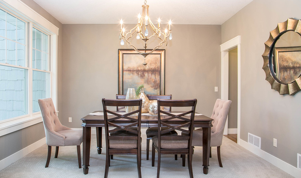 This is an example of a traditional separate dining room in Minneapolis with grey walls, carpet and no fireplace.