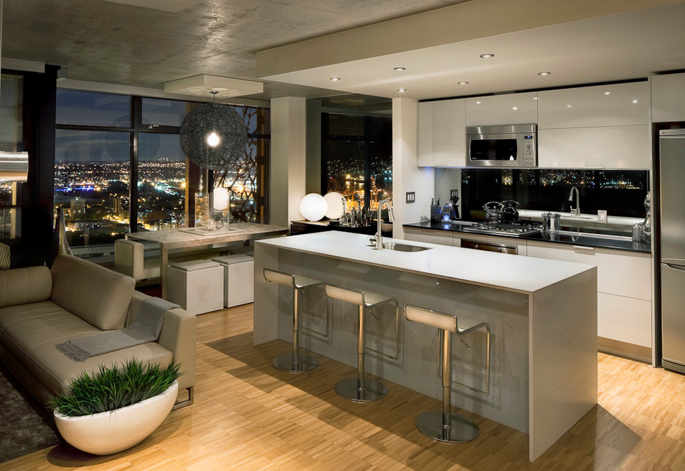 This is an example of a modern open plan kitchen in Vancouver with stainless steel appliances.