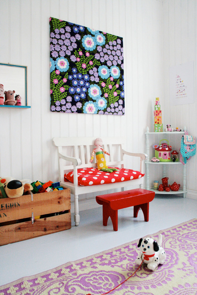Inspiration for a traditional kids' playroom for kids 4-10 years old and girls in Munich with white walls, painted wood floors and grey floor.