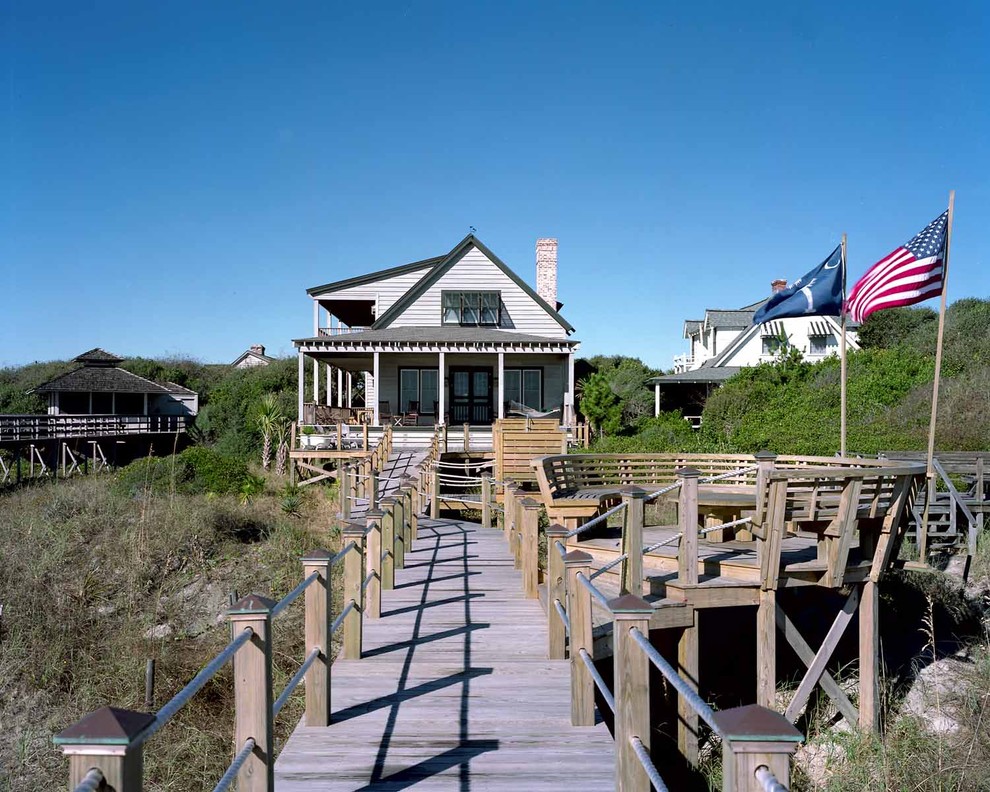 This is an example of a small beach style two-storey exterior in Charleston with wood siding.