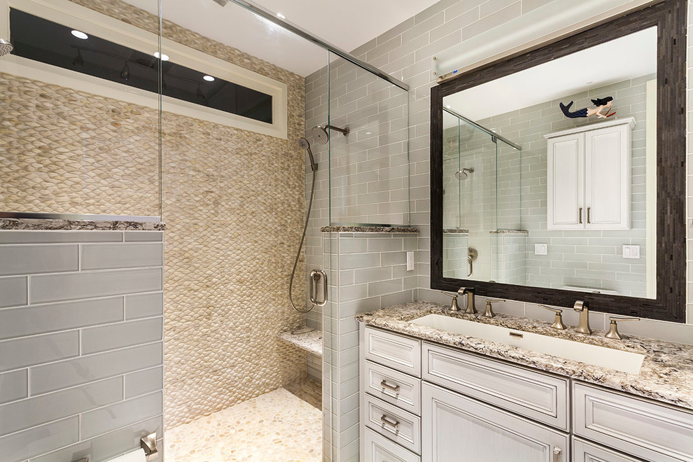 Example of a mid-sized transitional master gray tile and glass tile porcelain tile double shower design with recessed-panel cabinets, gray cabinets, a two-piece toilet, a trough sink and quartz countertops
