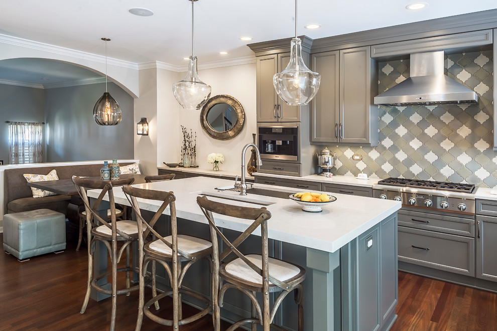 Inspiration for a mid-sized transitional u-shaped dark wood floor eat-in kitchen remodel in Chicago with an undermount sink, recessed-panel cabinets, gray cabinets, granite countertops, multicolored backsplash, porcelain backsplash, paneled appliances and an island