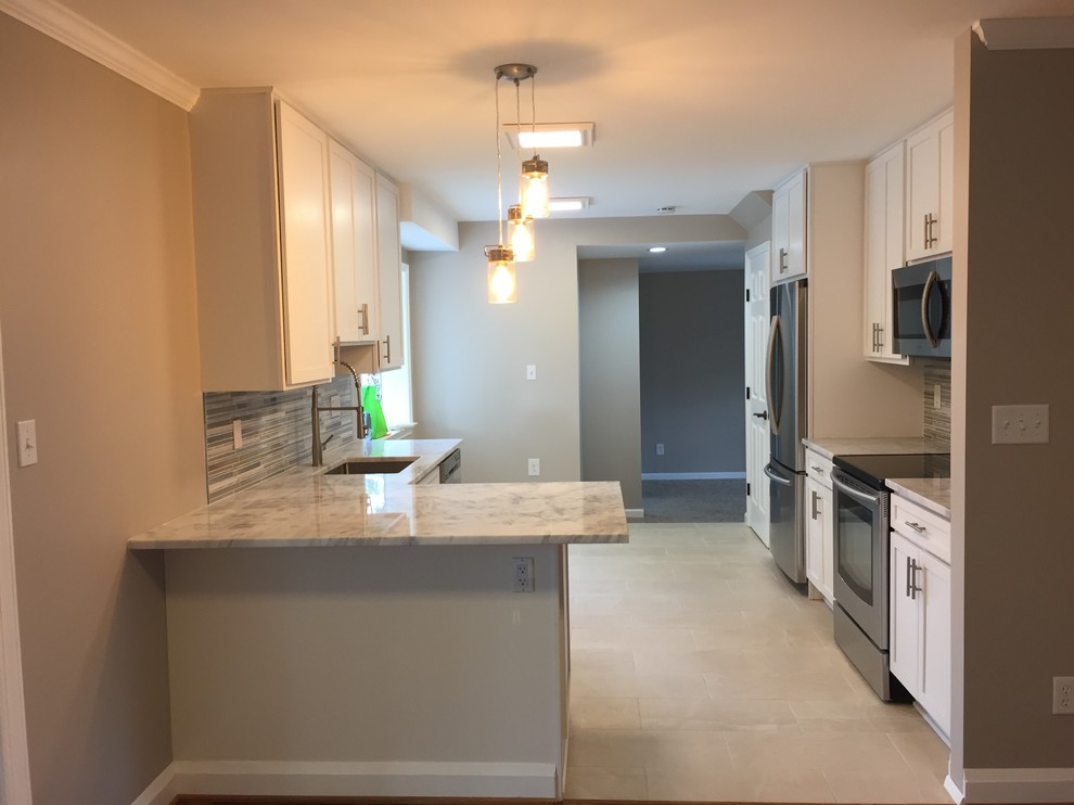 Example of a mid-sized transitional galley ceramic tile and beige floor eat-in kitchen design in Baltimore with an undermount sink, white cabinets, gray backsplash, ceramic backsplash, stainless steel appliances, a peninsula, recessed-panel cabinets and marble countertops