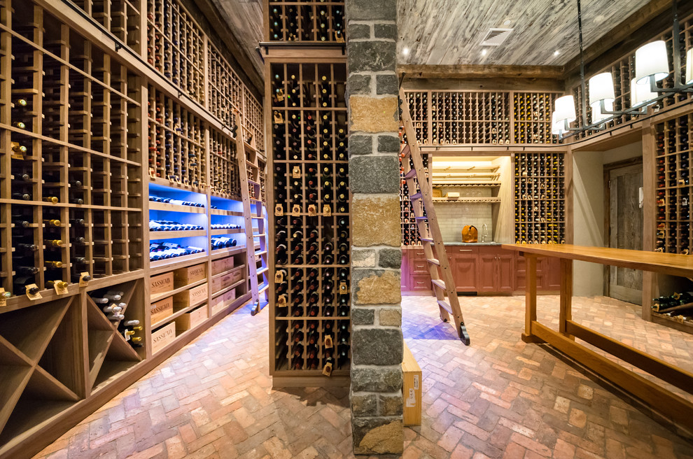 Inspiration for an expansive country wine cellar in New York with brick floors, storage racks and red floor.