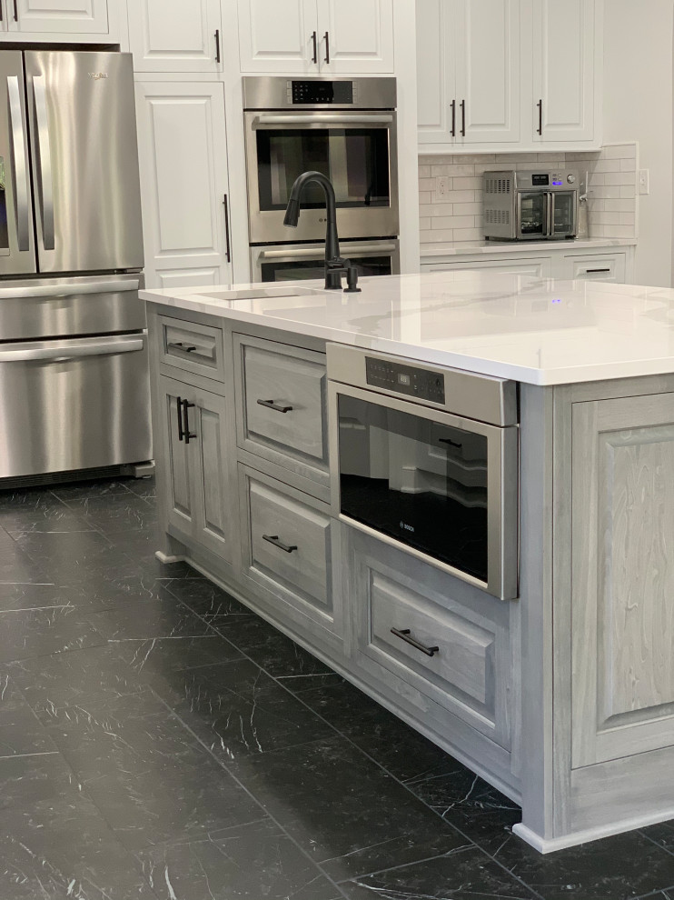 Inspiration for a transitional marble floor and black floor eat-in kitchen remodel with an undermount sink, quartz countertops, ceramic backsplash, stainless steel appliances, an island and white countertops