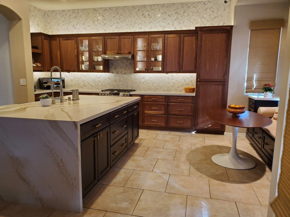 This is an example of a large traditional kitchen in Las Vegas with medium wood cabinets and an island.