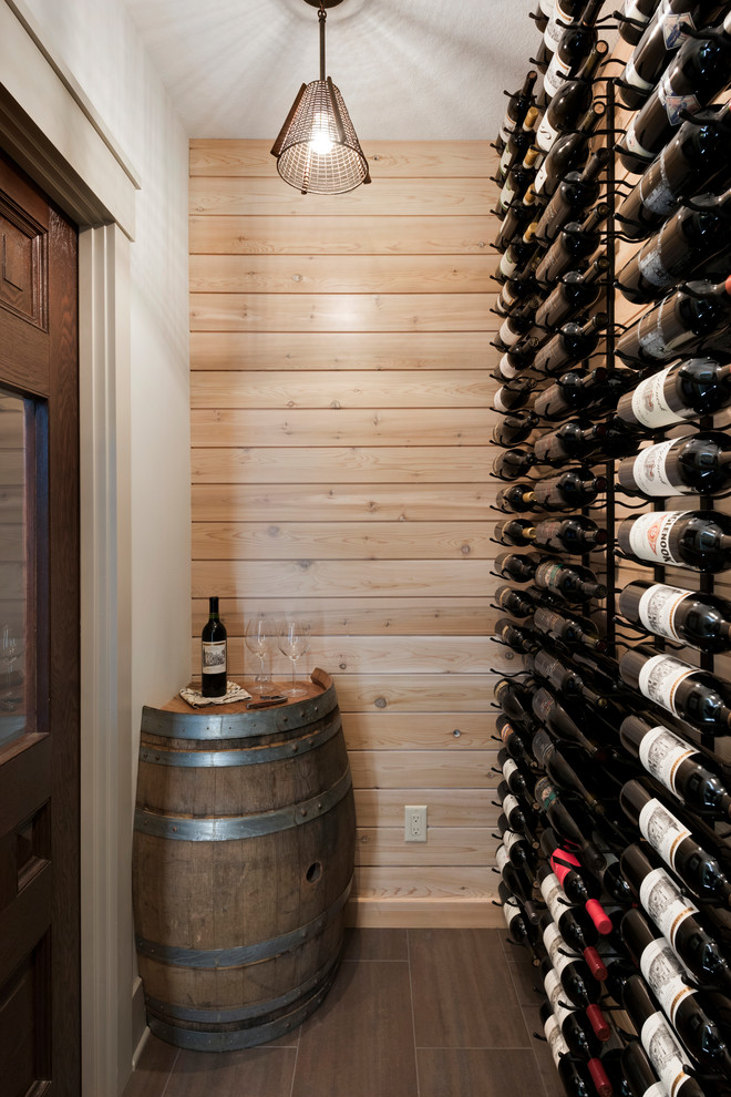 Small transitional wine cellar in Minneapolis with porcelain floors, storage racks and brown floor.