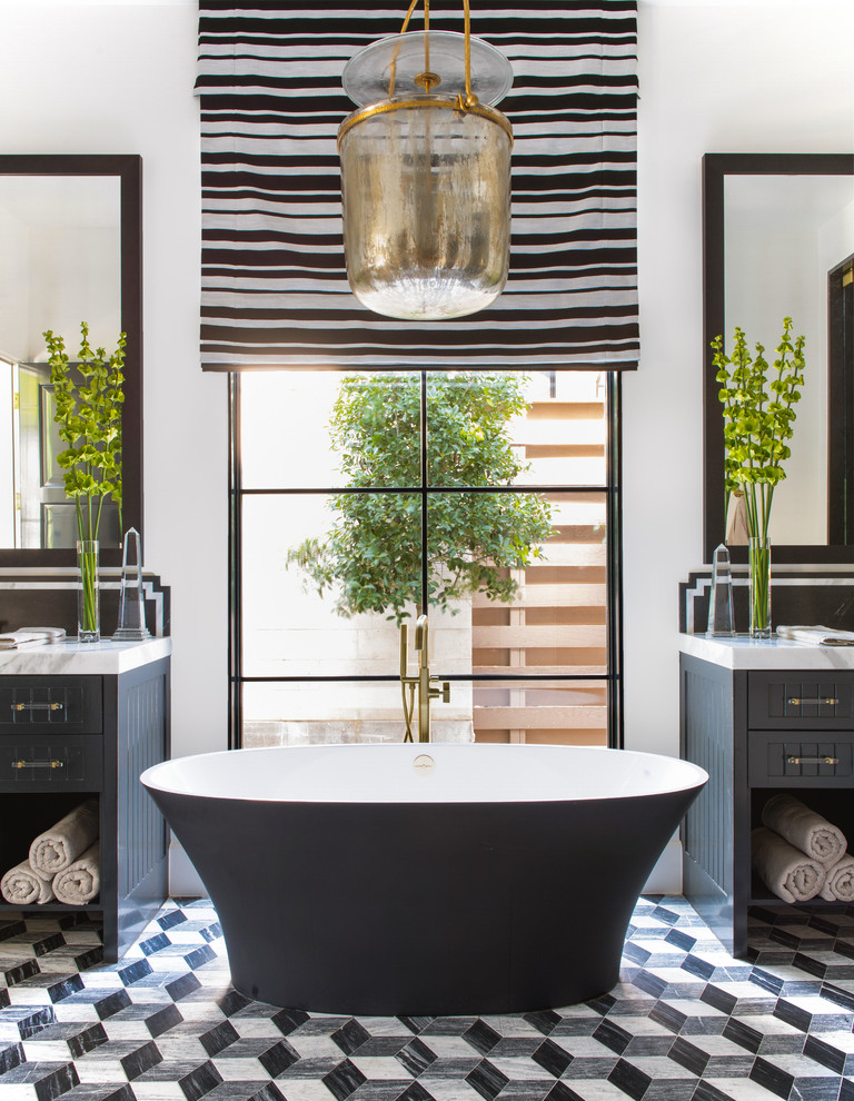 This is an example of a mediterranean master bathroom in Dallas with shaker cabinets, black cabinets, a freestanding tub, white walls, marble floors, multi-coloured floor and grey benchtops.