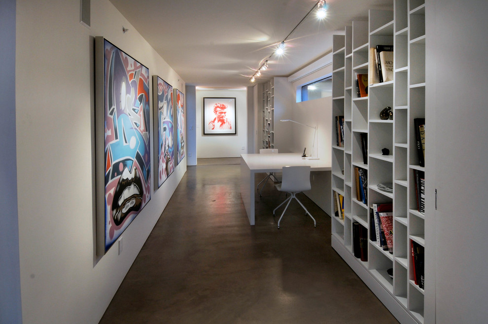 Photo of a contemporary home office in Phoenix with concrete floors and white walls.