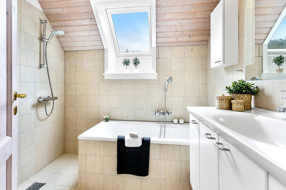 Photo of a transitional bathroom in Copenhagen with flat-panel cabinets, white cabinets, a drop-in tub, an open shower, beige walls and beige floor.