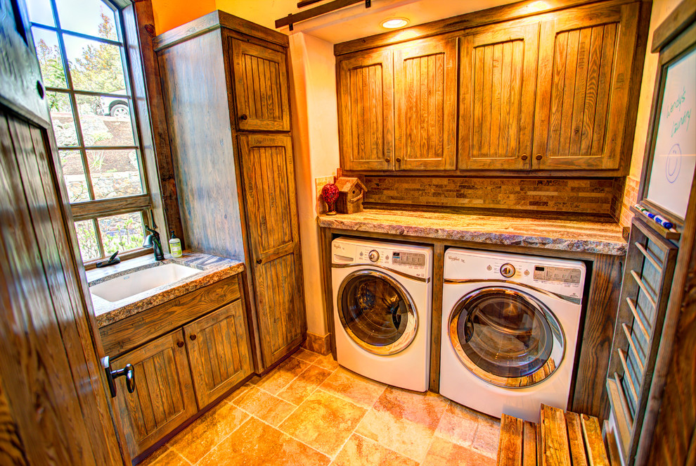 Inspiration for a mid-sized country l-shaped dedicated laundry room in Other with an undermount sink, flat-panel cabinets, granite benchtops, beige walls, terra-cotta floors, a side-by-side washer and dryer and dark wood cabinets.