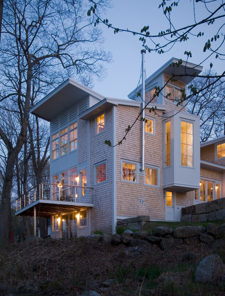 Inspiration for a contemporary three-storey white exterior in Portland Maine with wood siding and a shed roof.