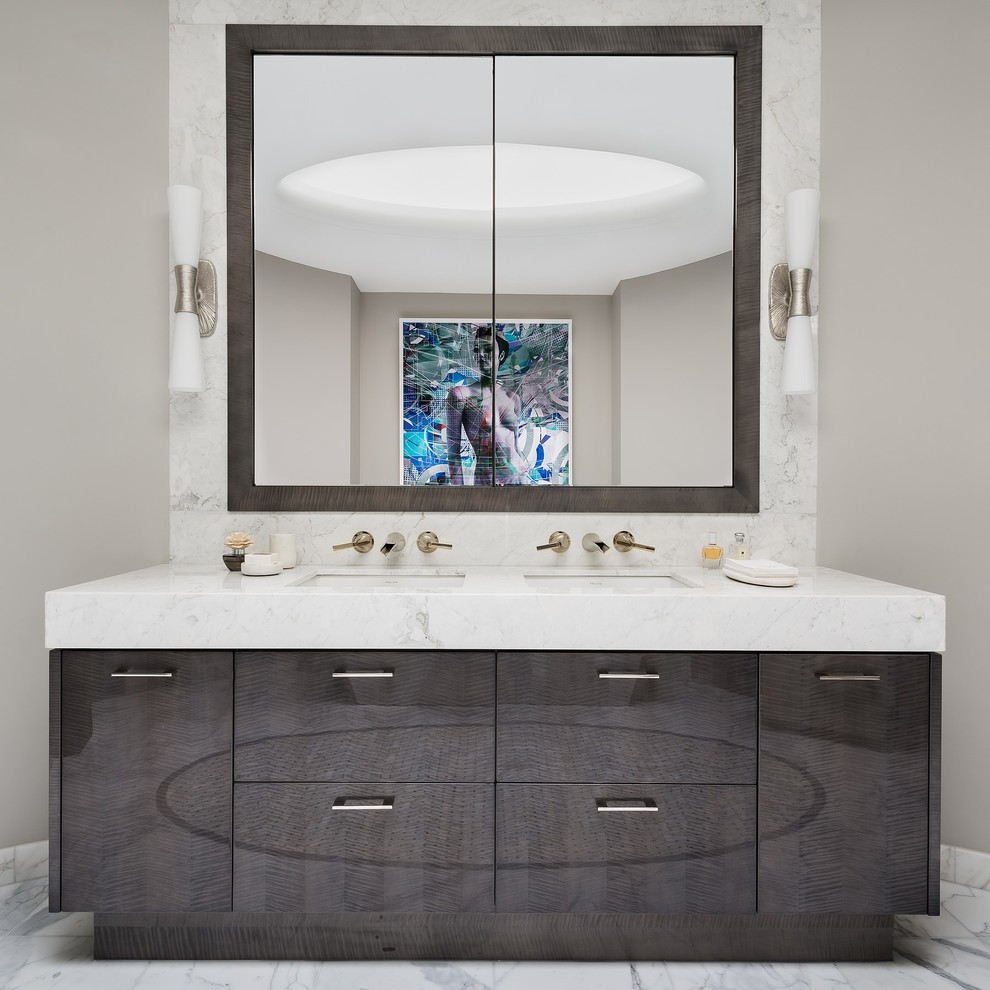 This is an example of a large contemporary master bathroom in Toronto with flat-panel cabinets, brown cabinets, beige walls, marble floors, an undermount sink, marble benchtops, white floor, white benchtops, a double vanity, a built-in vanity and vaulted.