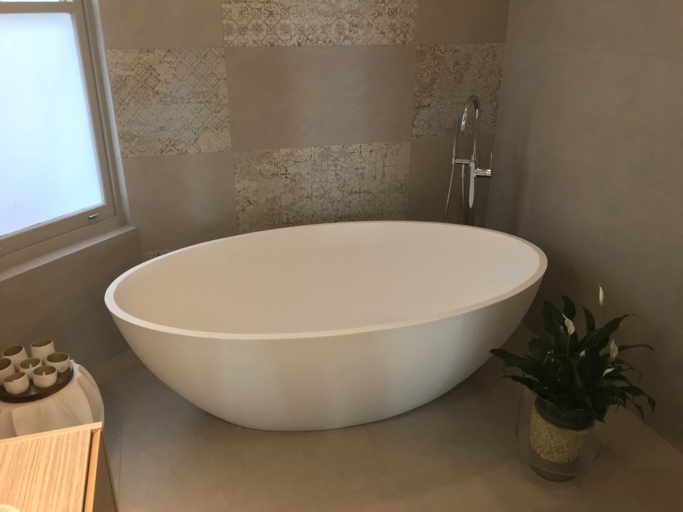 Inspiration for a large modern master bathroom in Sydney with raised-panel cabinets, white cabinets, a freestanding tub, an open shower, multi-coloured tile, stone tile, porcelain floors, a vessel sink and solid surface benchtops.