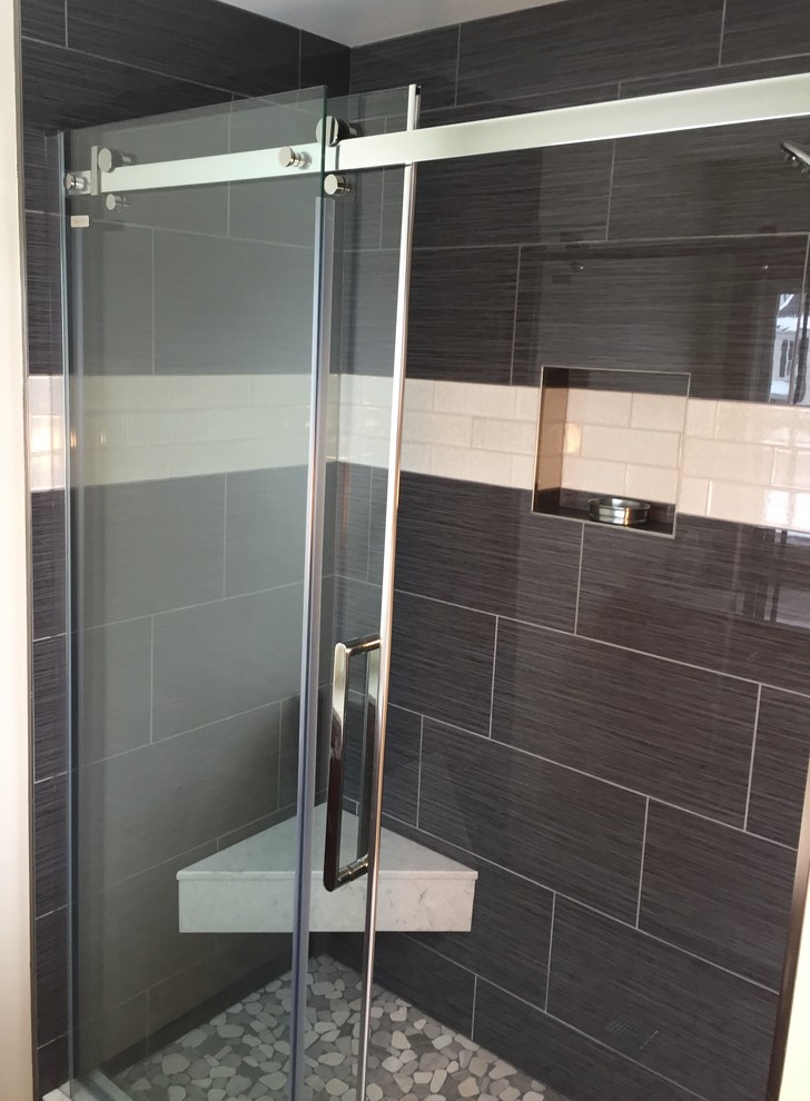 Mid-sized transitional master gray tile and porcelain tile porcelain tile and gray floor alcove shower photo in Chicago with recessed-panel cabinets, dark wood cabinets, beige walls, an undermount sink and quartz countertops