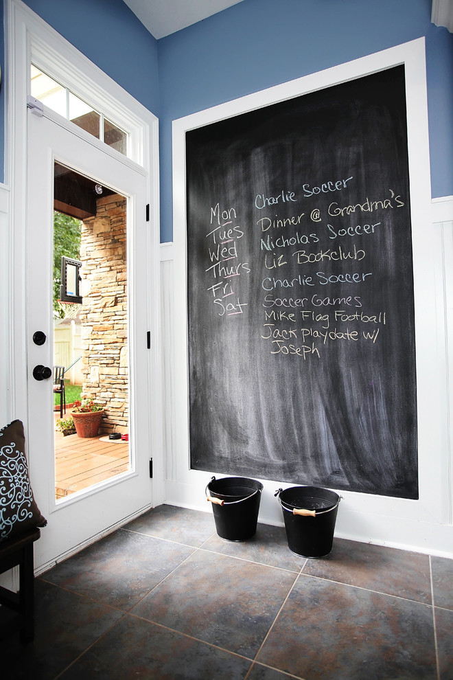 Photo of a country mudroom in Charlotte with blue walls.