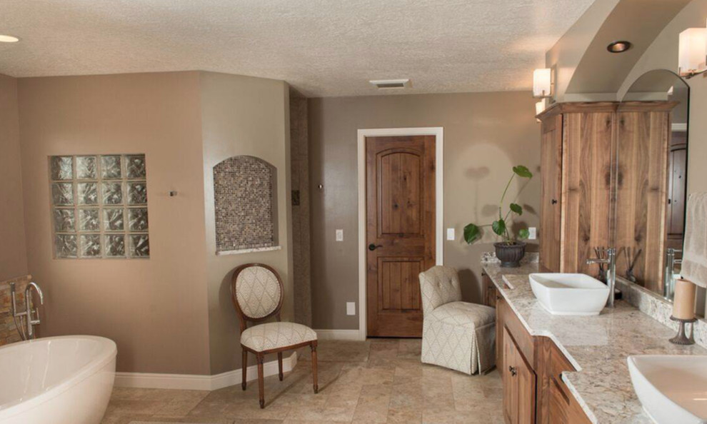 Large mountain style master freestanding bathtub photo with recessed-panel cabinets, medium tone wood cabinets and a vessel sink
