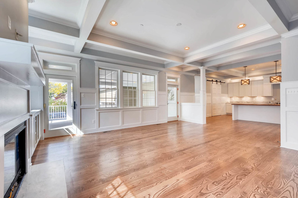 Large traditional enclosed family room in Baltimore with multi-coloured walls, medium hardwood floors and a standard fireplace.