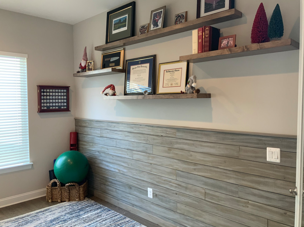 Mid-sized transitional study room in DC Metro with beige walls, medium hardwood floors, a built-in desk, brown floor and planked wall panelling.