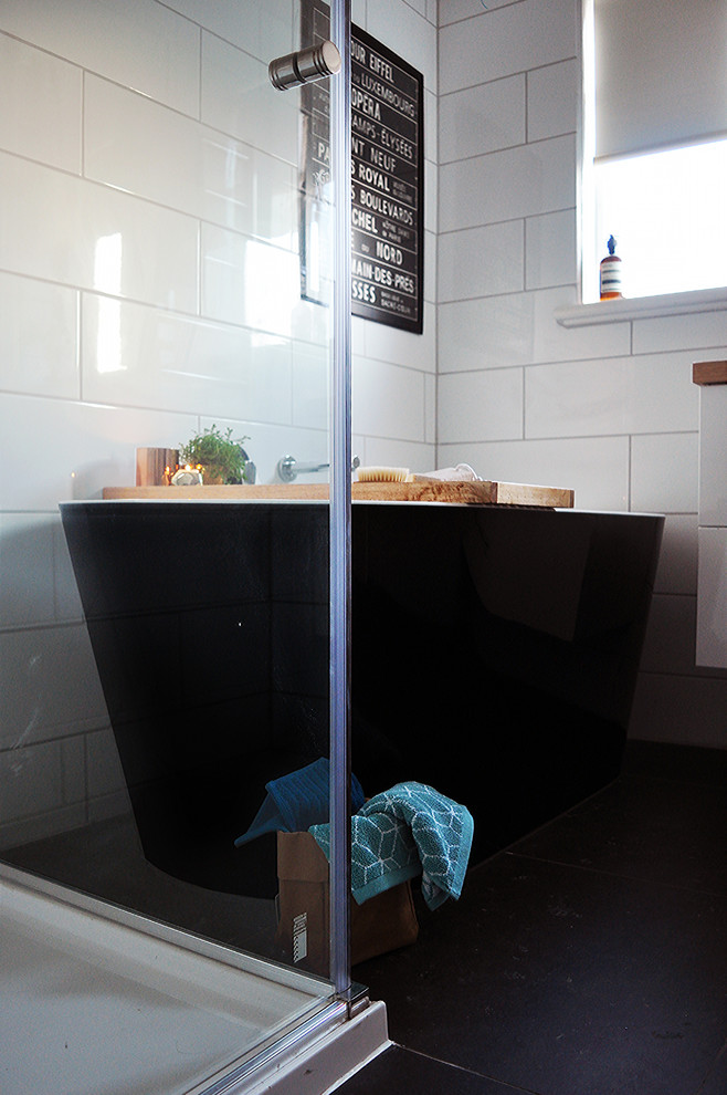 Design ideas for a small contemporary master bathroom in Melbourne with a freestanding tub, a corner shower, black and white tile, ceramic tile, white walls, ceramic floors, a vessel sink and wood benchtops.