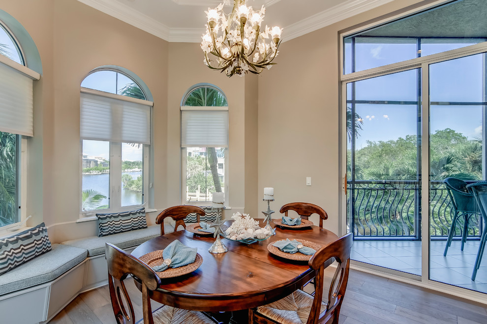 Example of a mid-sized transitional medium tone wood floor enclosed dining room design in Miami with beige walls
