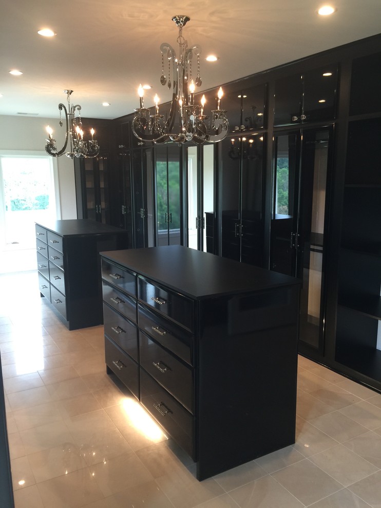 Inspiration for a large modern women's walk-in wardrobe in Nashville with flat-panel cabinets, black cabinets and porcelain floors.