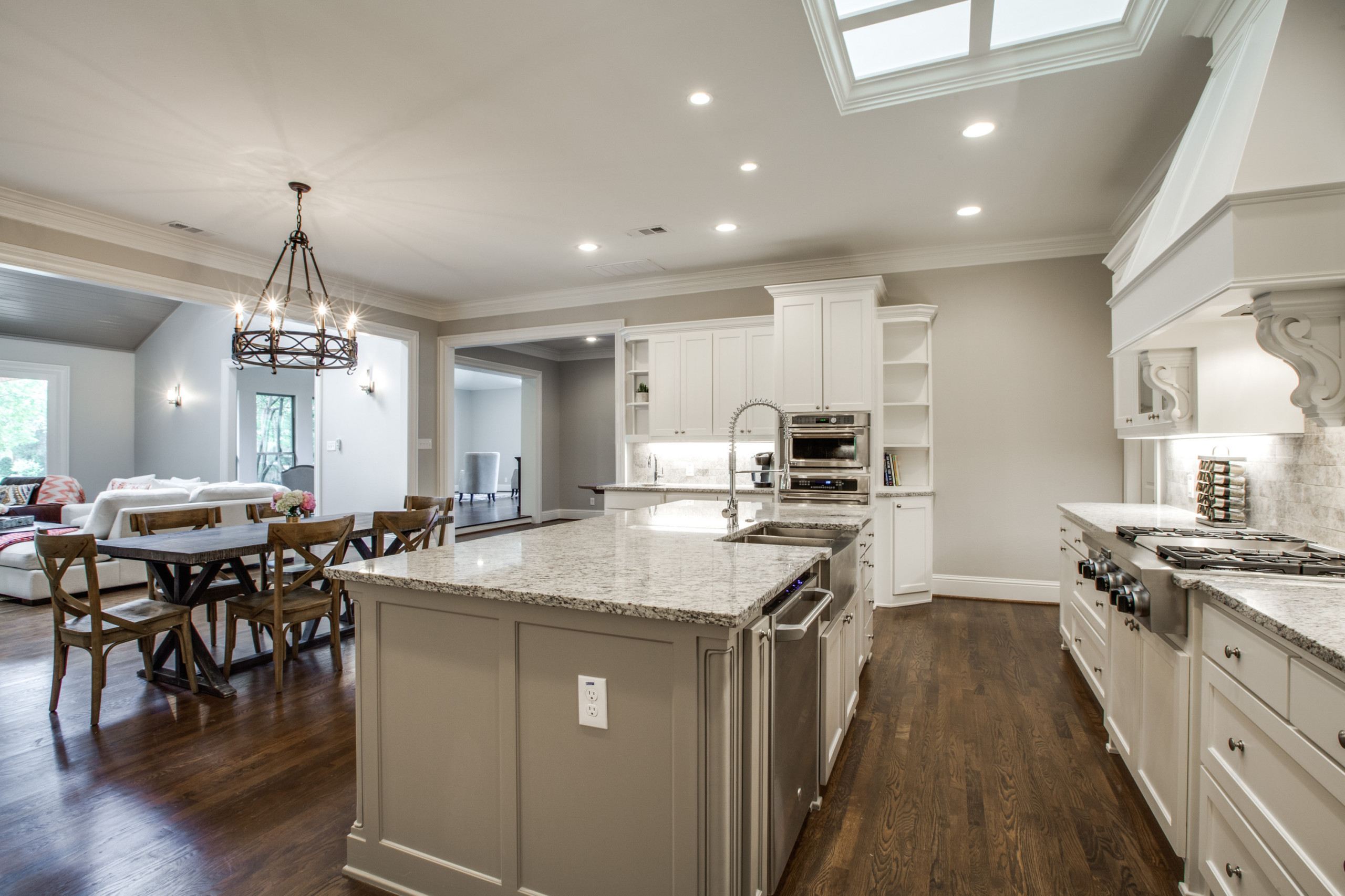 Spacious remodeled custom Transitional Kitchen and Dining Room with recessed cabinets, granite countertops and undemount sink, ceramic tile back splash, drop in and in wall stainless steel applicances