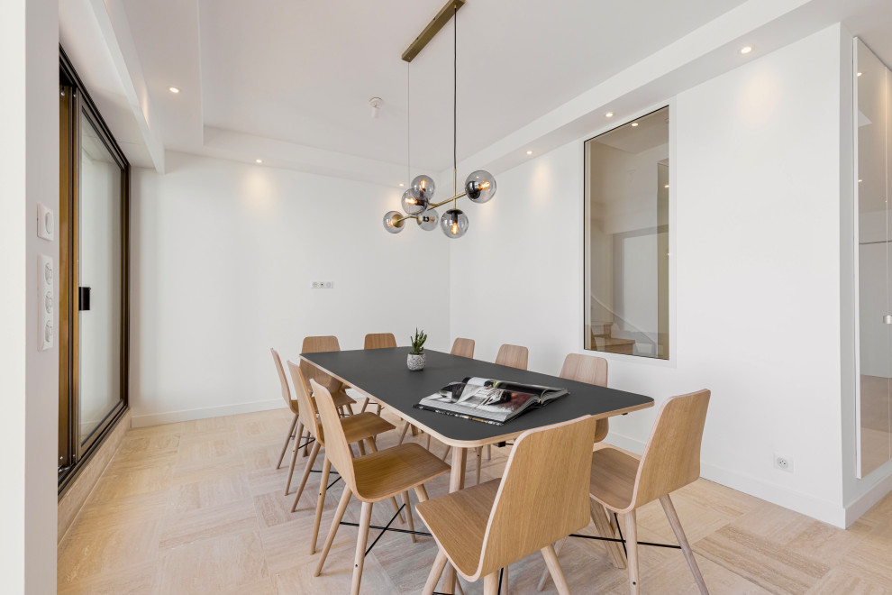 This is an example of a large contemporary open plan dining in Nice with white walls, marble floors, beige floor and recessed.