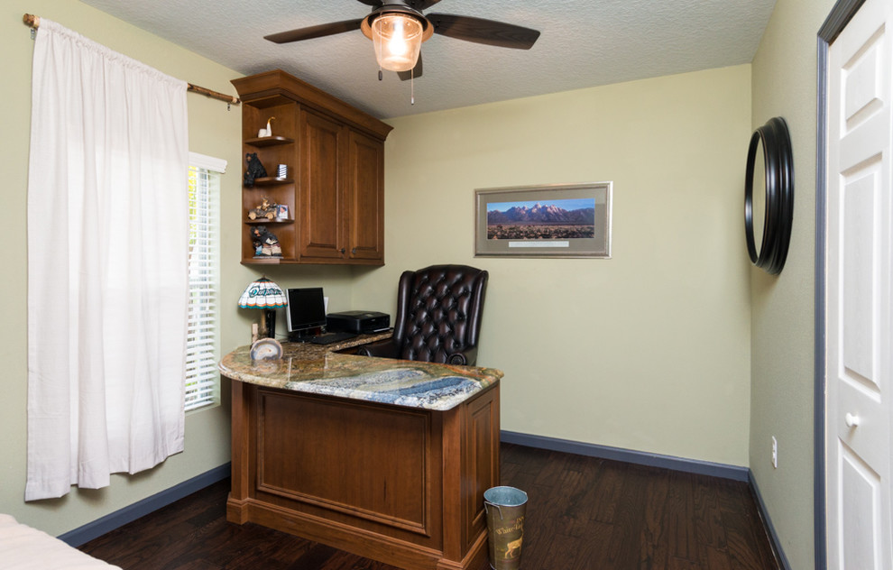 Photo of a small country study room in Orlando with a built-in desk, yellow walls, dark hardwood floors and no fireplace.