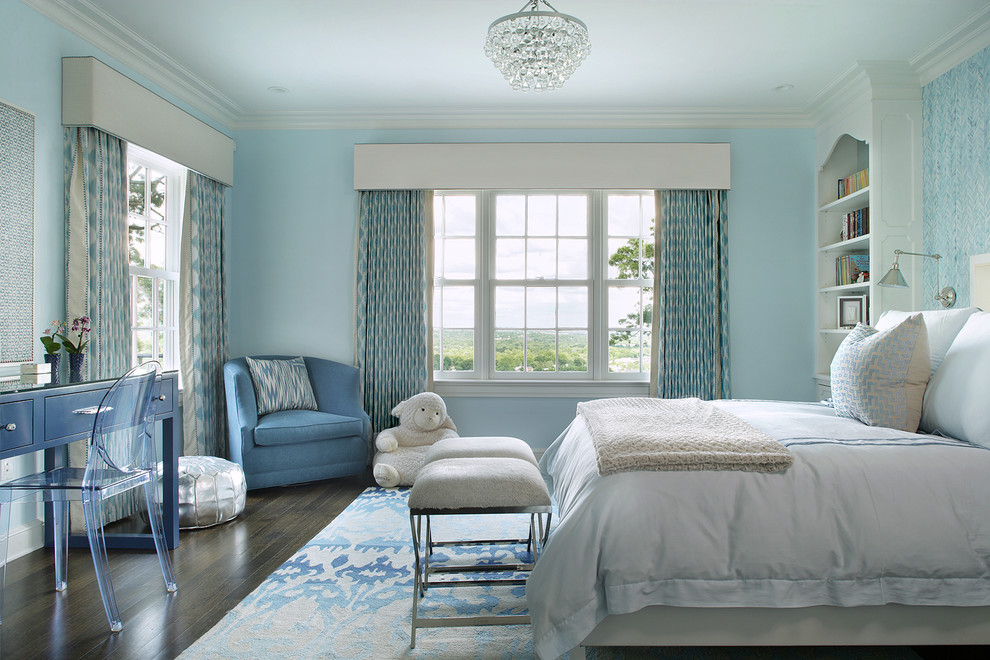 Photo of a large traditional kids' room for girls in New York with blue walls and dark hardwood floors.