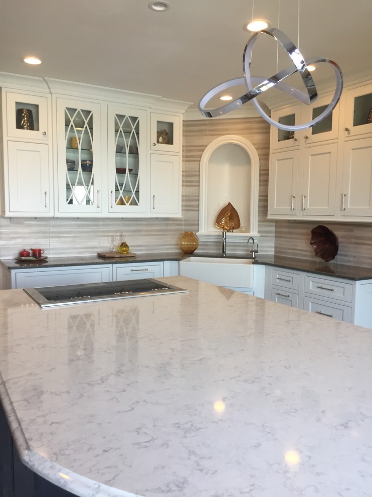 Large transitional ceramic tile and multicolored floor kitchen photo with a farmhouse sink, beaded inset cabinets, white cabinets, quartz countertops, metallic backsplash, ceramic backsplash, stainless steel appliances and an island