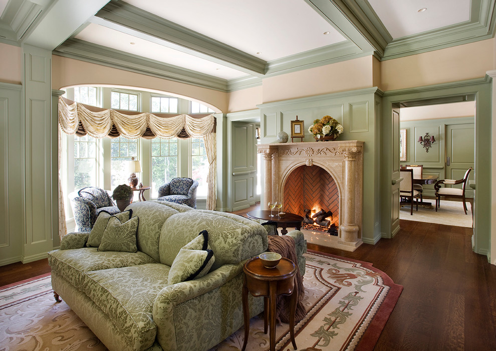 Design ideas for a traditional enclosed living room in Boston with green walls, dark hardwood floors, a standard fireplace and no tv.