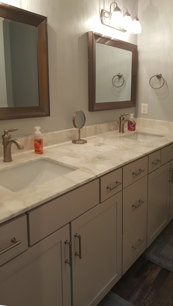 This is an example of a mid-sized transitional bathroom in Other with shaker cabinets, grey cabinets, onyx benchtops, brown floor and grey benchtops.
