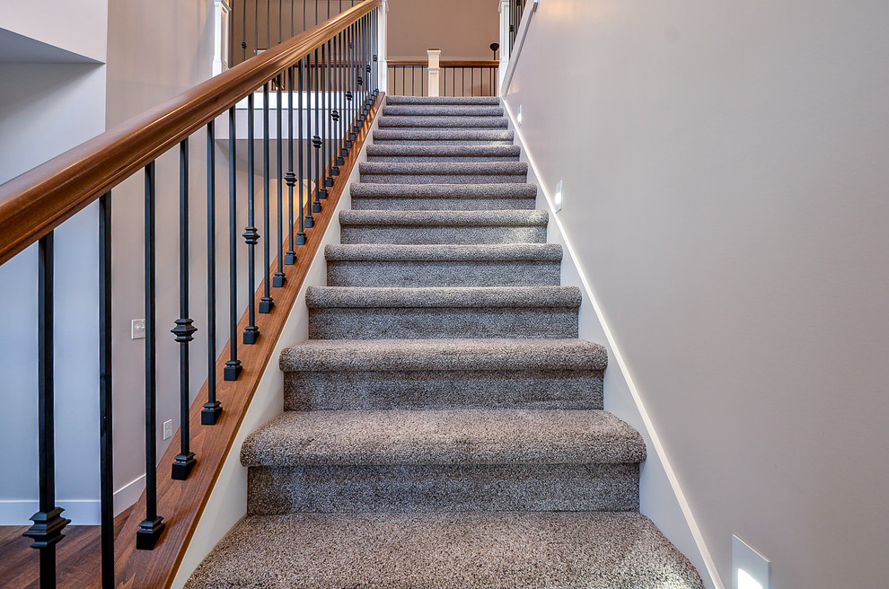 Photo of a small traditional carpeted straight staircase in Other with carpet risers and mixed railing.