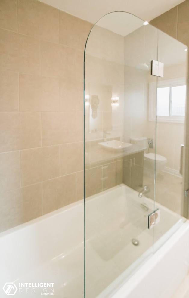 Mid-sized transitional master beige tile and ceramic tile porcelain tile, beige floor and double-sink alcove bathtub photo in Toronto with flat-panel cabinets, dark wood cabinets, a one-piece toilet, pink walls, a vessel sink, marble countertops, a hinged shower door, gray countertops and a freestanding vanity