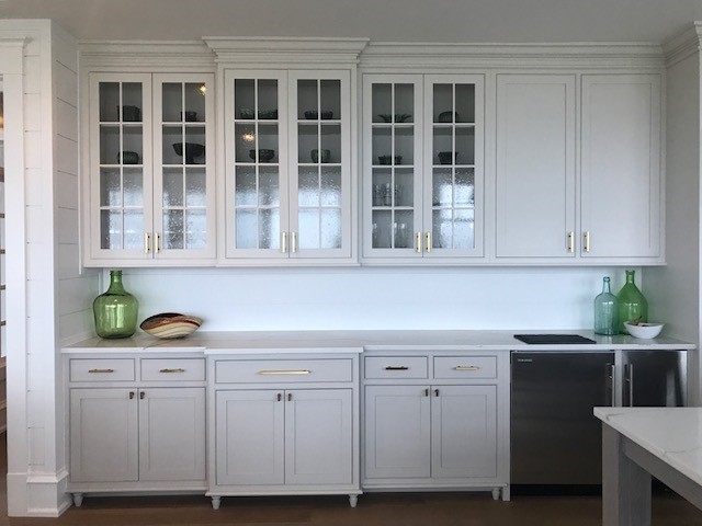 Design ideas for a large country l-shaped eat-in kitchen in Philadelphia with a farmhouse sink, beaded inset cabinets, grey cabinets, quartzite benchtops, white splashback, ceramic splashback, stainless steel appliances, medium hardwood floors, with island and orange floor.