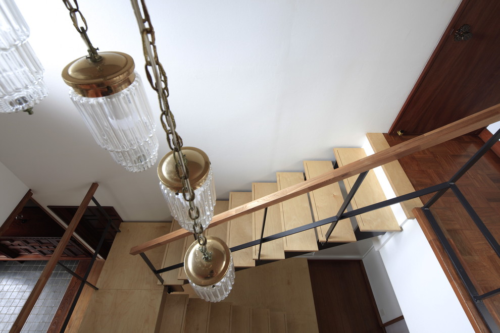 Photo of an asian wood u-shaped staircase in Tokyo Suburbs with open risers.