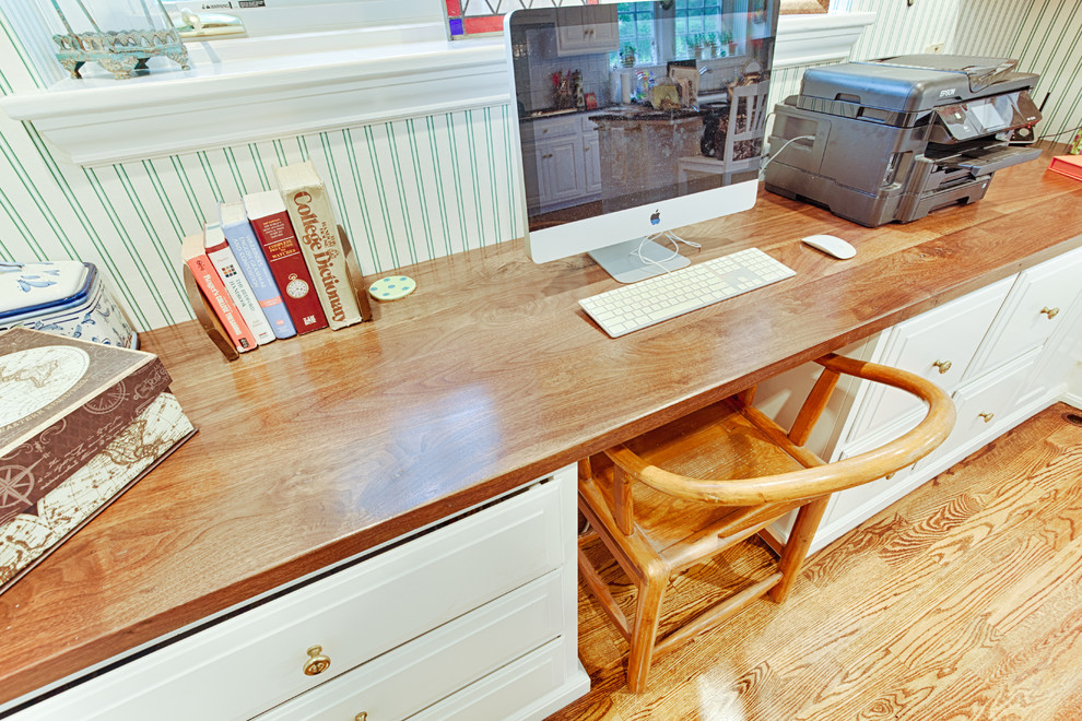 Mid-sized traditional home office in Philadelphia with white walls, light hardwood floors and a built-in desk.