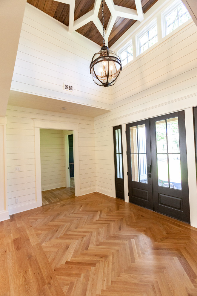 Foyer - mid-sized transitional foyer idea with a black front door