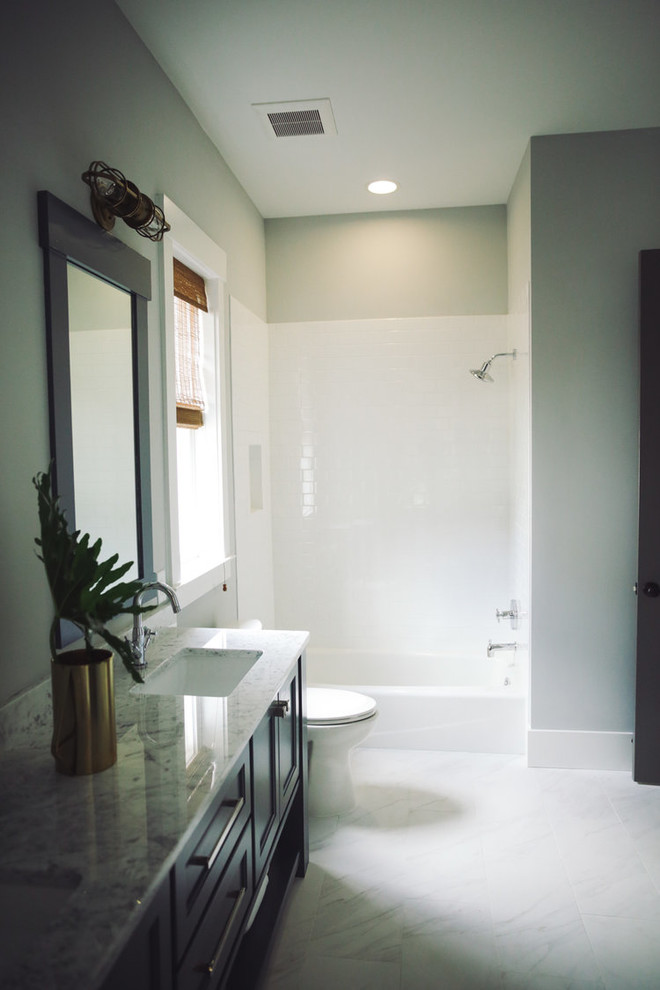Inspiration for a transitional bathroom in Atlanta with dark wood cabinets, an alcove tub, an alcove shower, a one-piece toilet, white tile, subway tile, green walls, marble floors and marble benchtops.